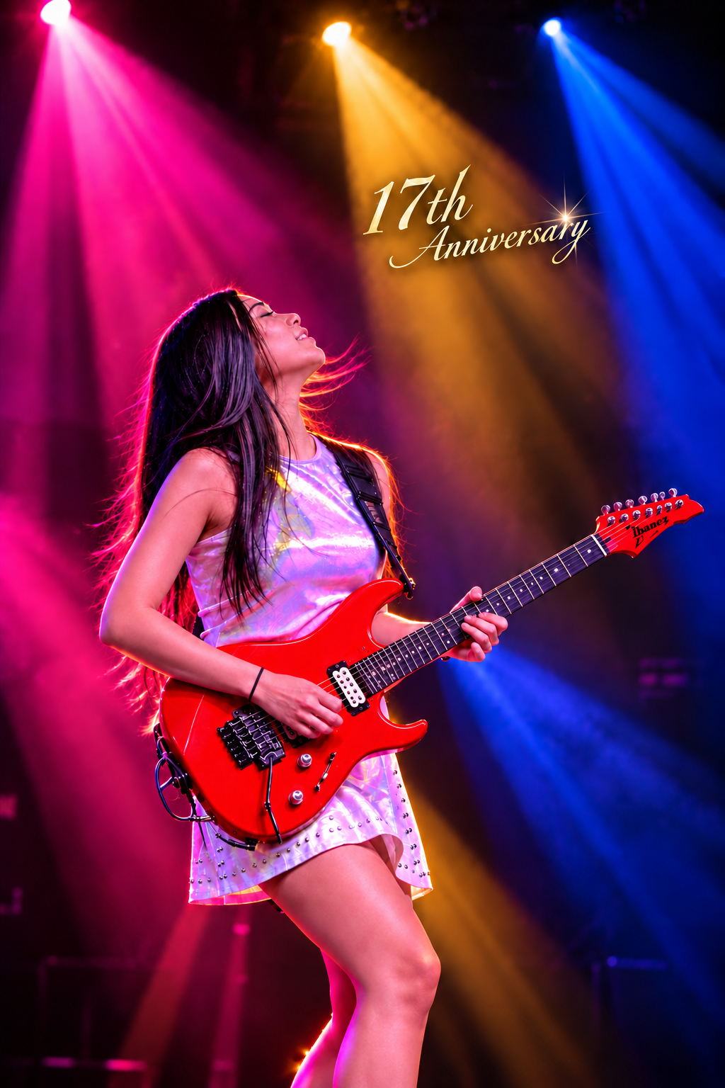 Petch with a red guitar under stage lights